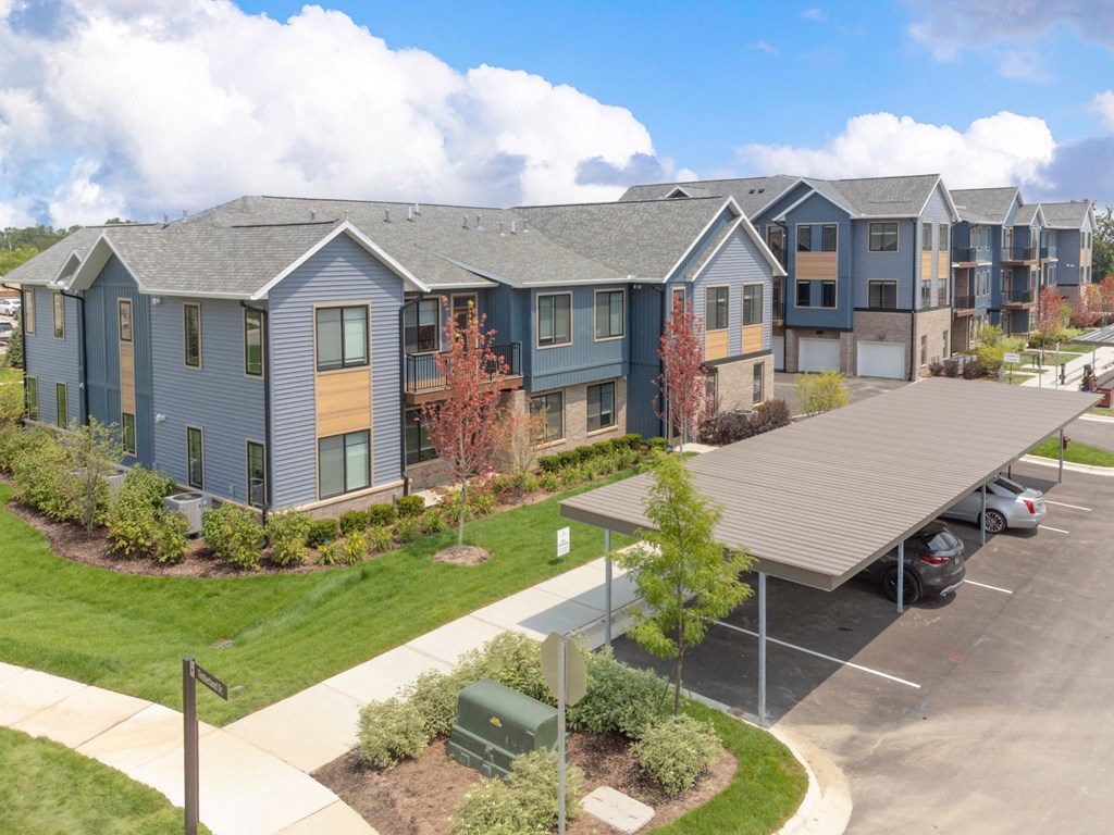 an aerial view of an apartment building with a parking lot